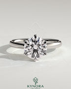 Kynora CJ 2ct round diamond claw solitaire engagement ring with a solid cathedral high setting, showcasing elegant jewelry craftsmanship.