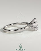 Kynora CJ 2ct round diamond solitaire engagement ring with solid cathedral high setting and claw prongs.