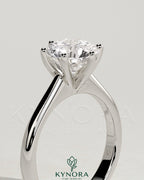 Kynora CJ 2ct round diamond claw solitaire engagement ring with solid cathedral low setting on a ring model.