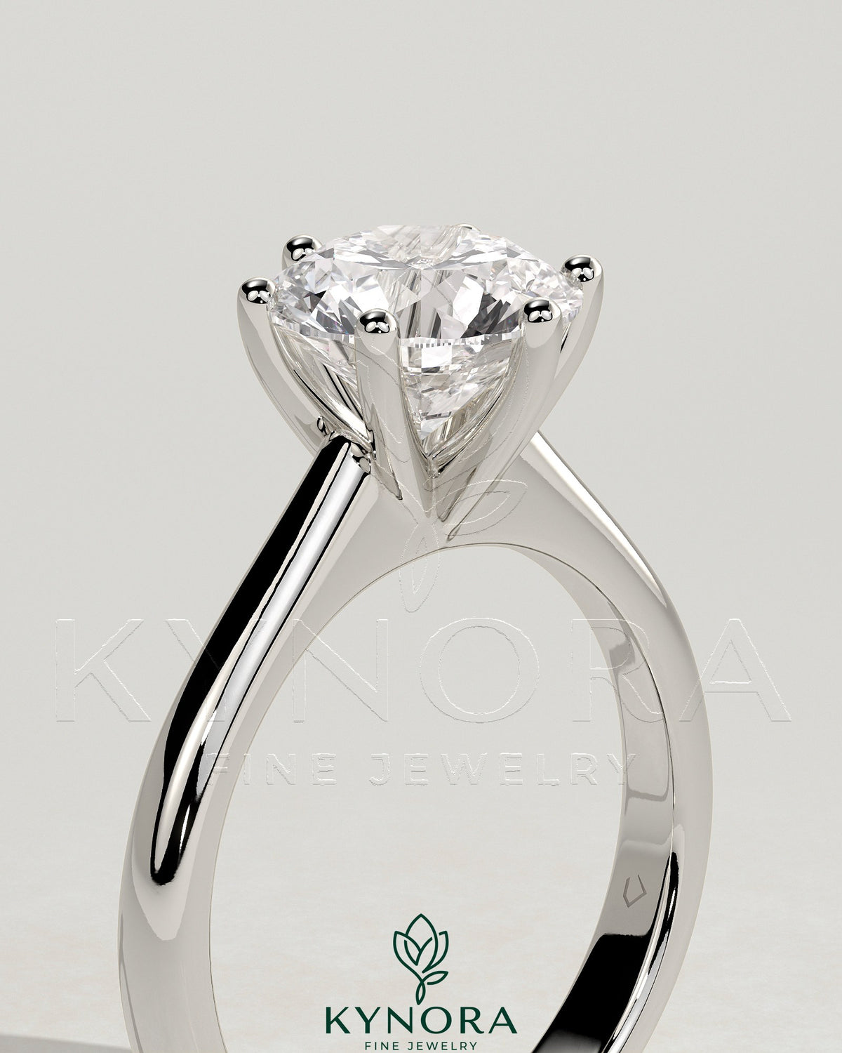 Kynora CJ 2ct round diamond claw solitaire engagement ring with solid cathedral low setting on a ring model.