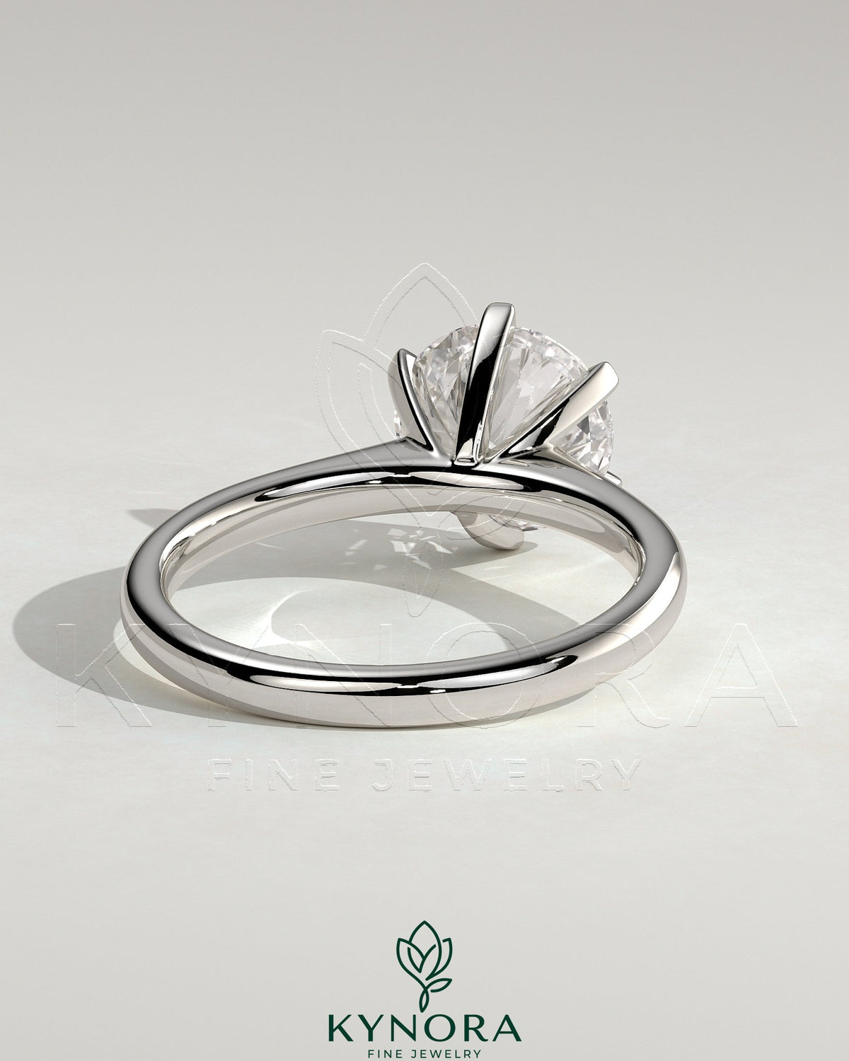 Kynora CJ 2ct round claw solitaire engagement ring with square tips and cathedral high setting, showcasing elegant jewelry design.