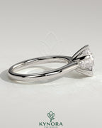 Kynora CJ 2ct round claw solitaire engagement ring with square tips and high cathedral setting, elegant and sparkling jewelry piece.