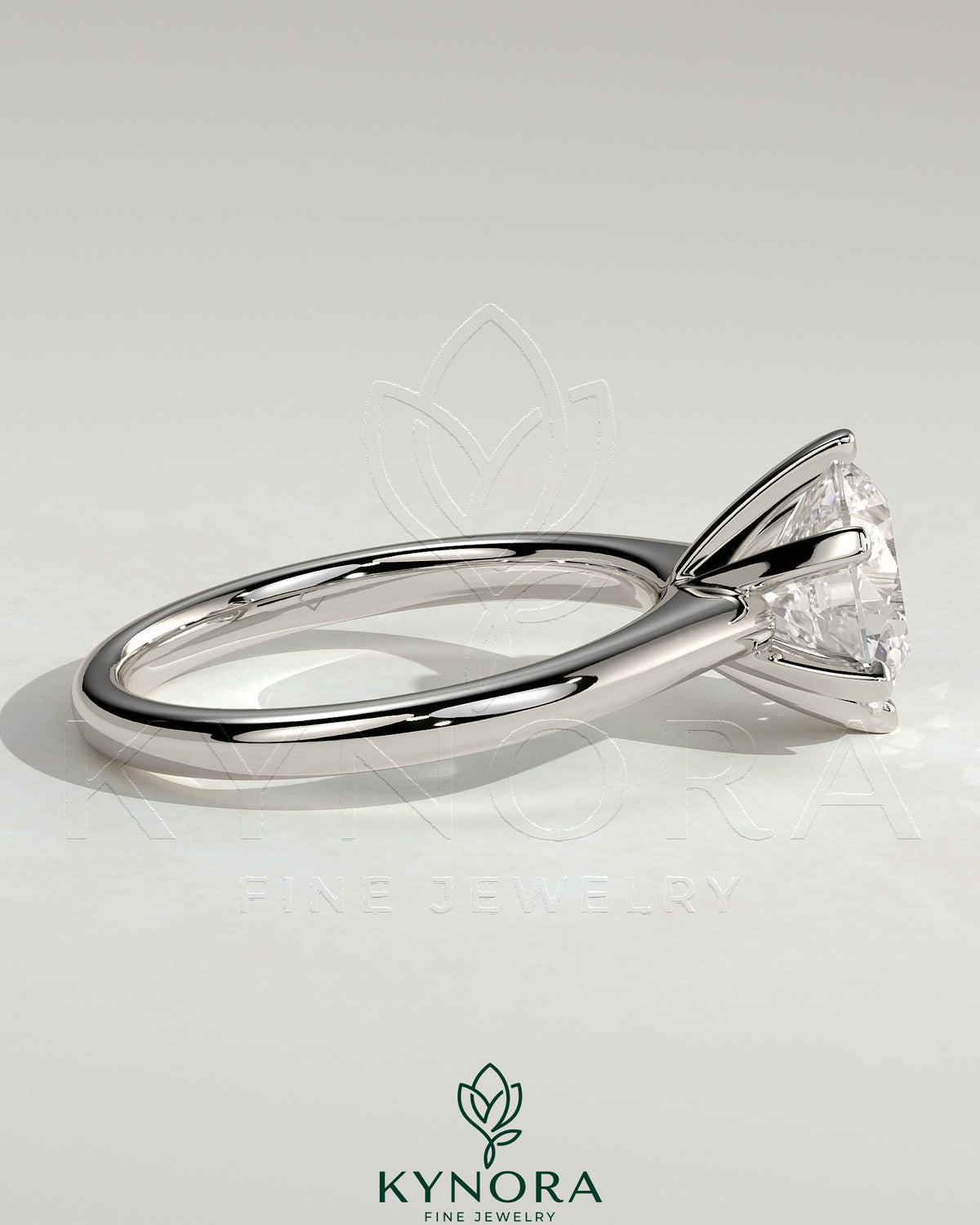 Kynora CJ 2ct round claw solitaire engagement ring with square tips and high cathedral setting, elegant and sparkling jewelry piece.