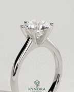 Kynora CJ 2-carat round claw solitaire engagement ring with square tips and high cathedral setting, showcasing elegant jewelry design