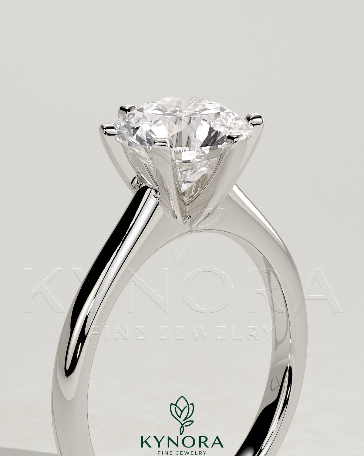 Kynora CJ 2-carat round claw solitaire engagement ring with square tips and high cathedral setting, showcasing elegant jewelry design