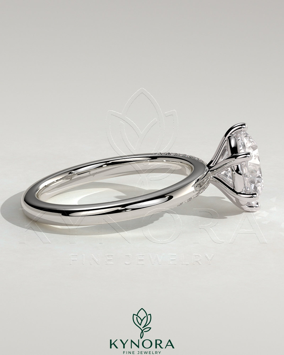 Kynora CJ 2ct round claw solitaire engagement ring with sweeping micropavé band, showcasing a sparkling central diamond and elegant design.