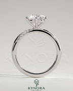 Kynora CJ 2ct round diamond solitaire engagement ring with sweeping micropavé band, elegant and sparkling jewelry piece.