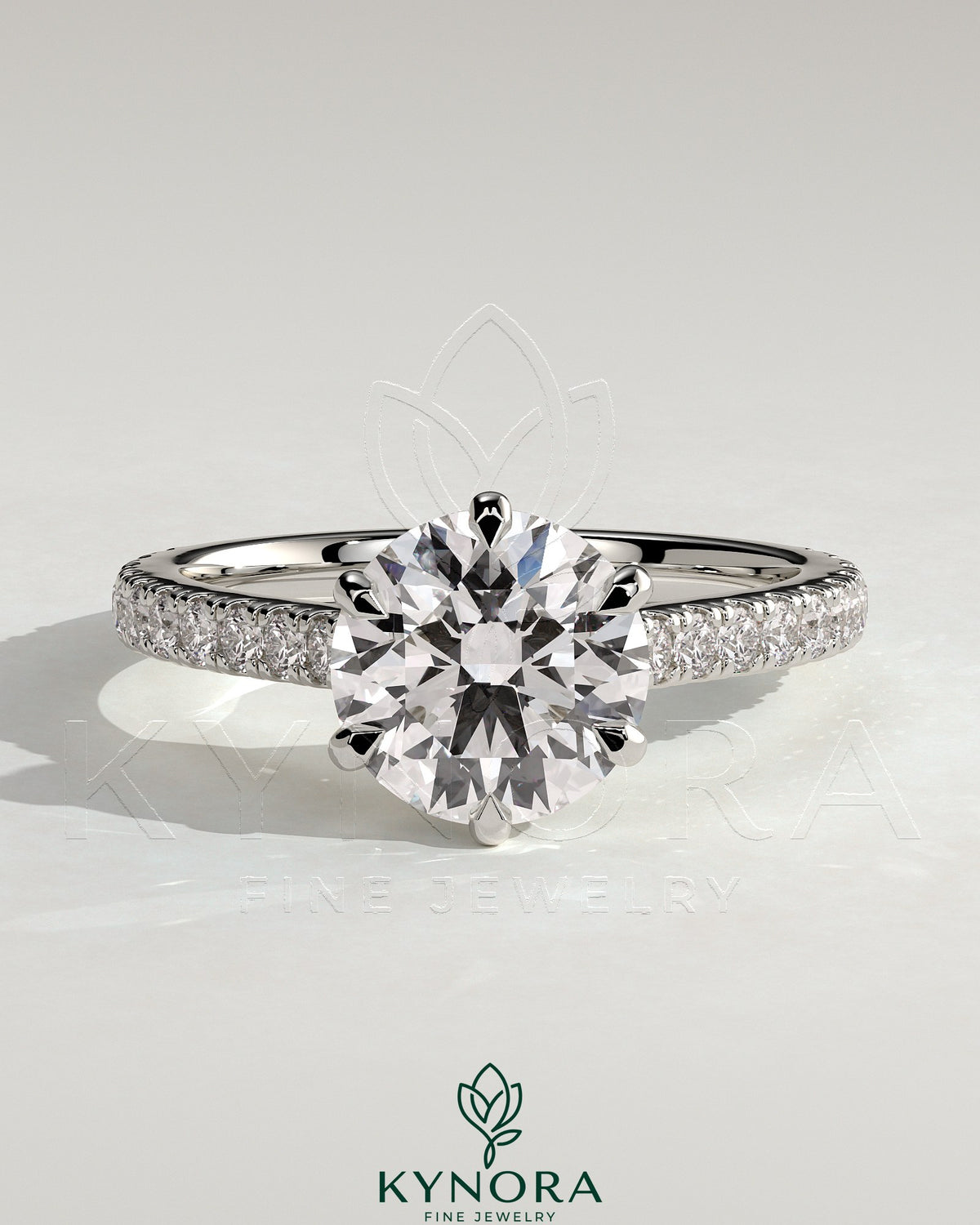 Kynora CJ 2ct round diamond claw solitaire engagement ring with trellis gallery, pave band, and cathedral low setting. Imagen principal del producto