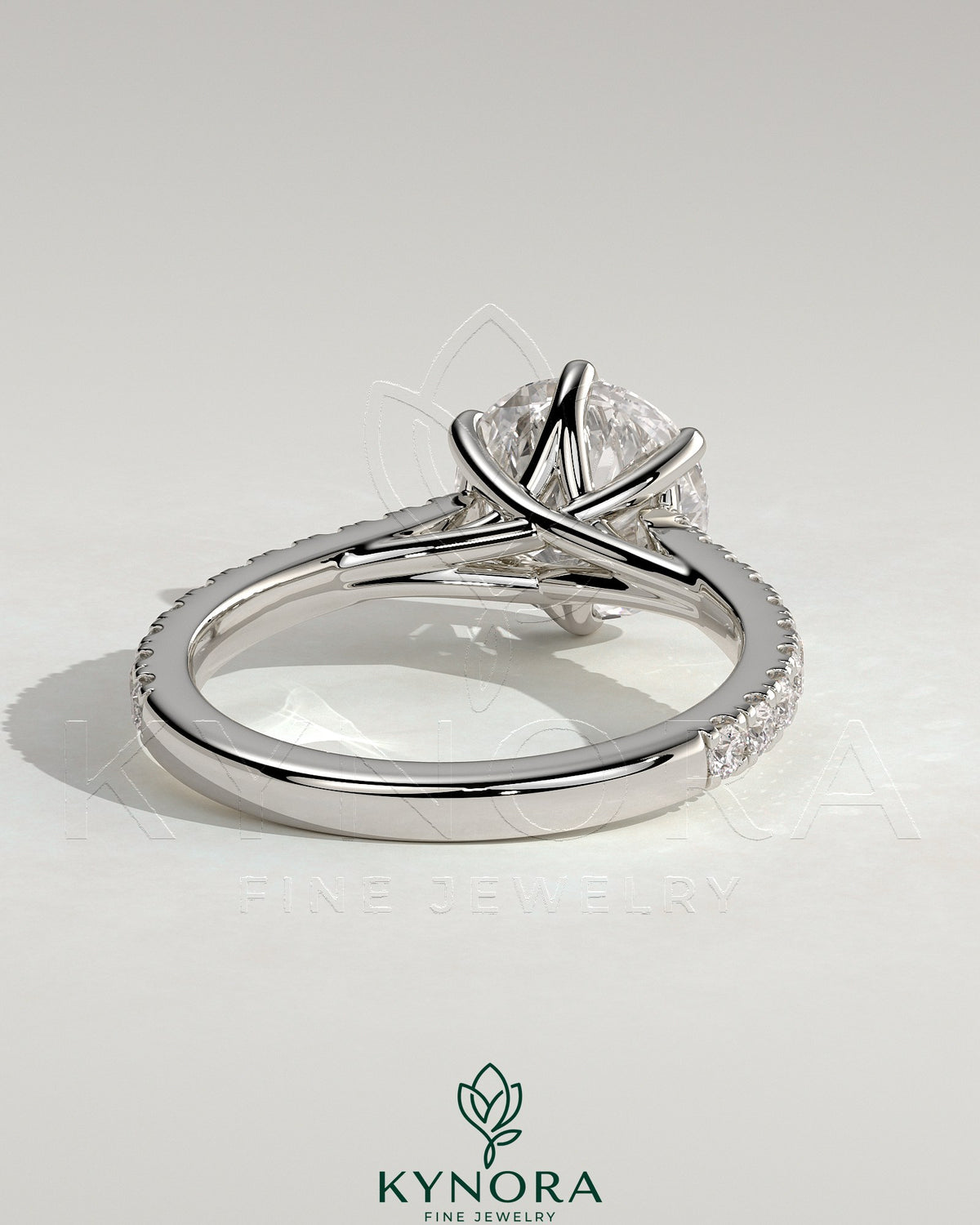 Kynora CJ 2ct round claw solitaire engagement ring with trellis gallery, pave band, and cathedral low setting.