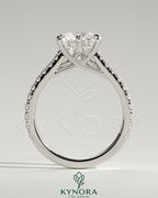 Kynora CJ 2ct round solitaire engagement ring with trellis gallery, pave band, and cathedral low setting.