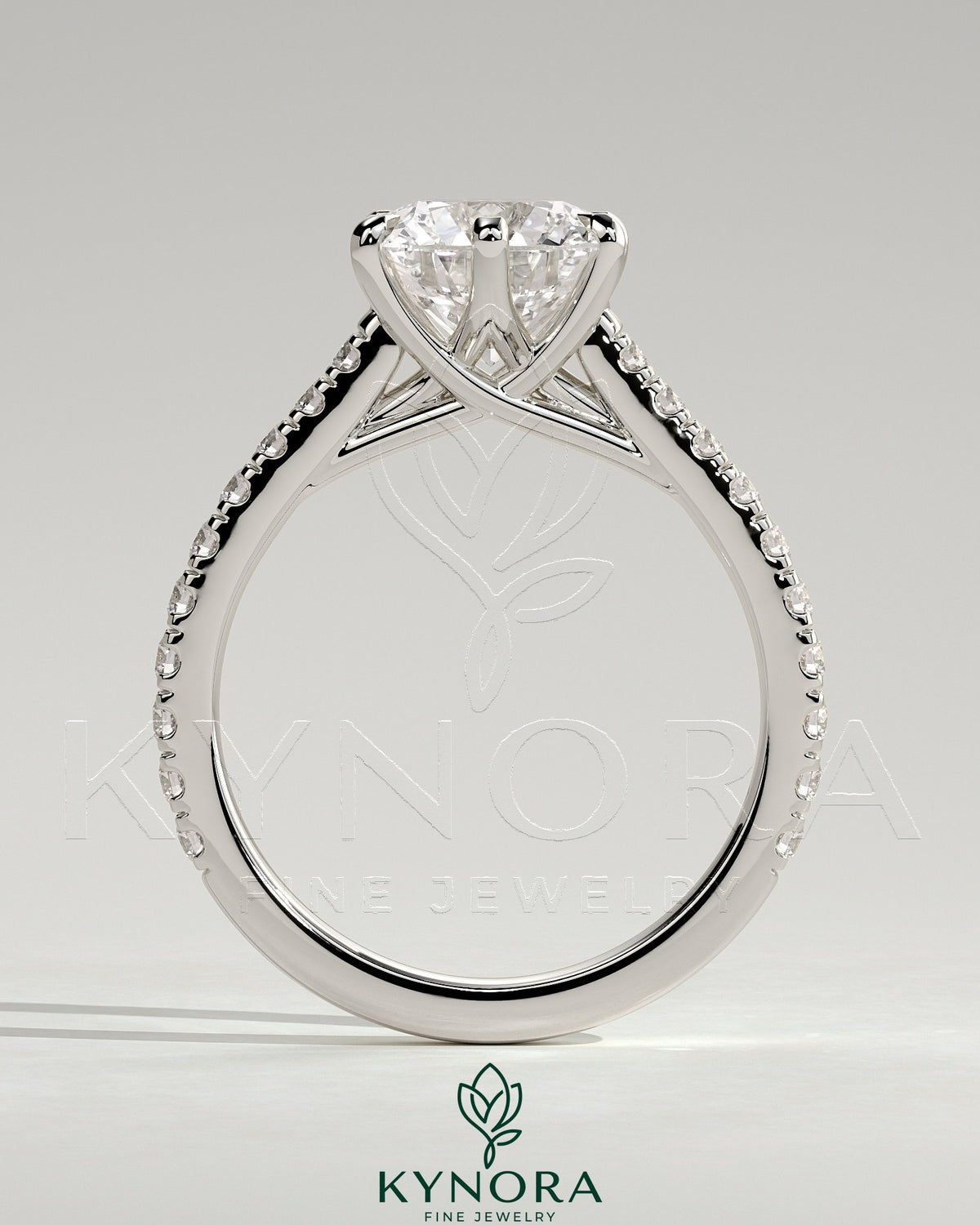 Kynora CJ 2ct round solitaire engagement ring with trellis gallery, pave band, and cathedral low setting.