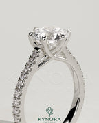 Kynora CJ 2ct round diamond solitaire engagement ring with trellis gallery, pave band, and cathedral low setting.