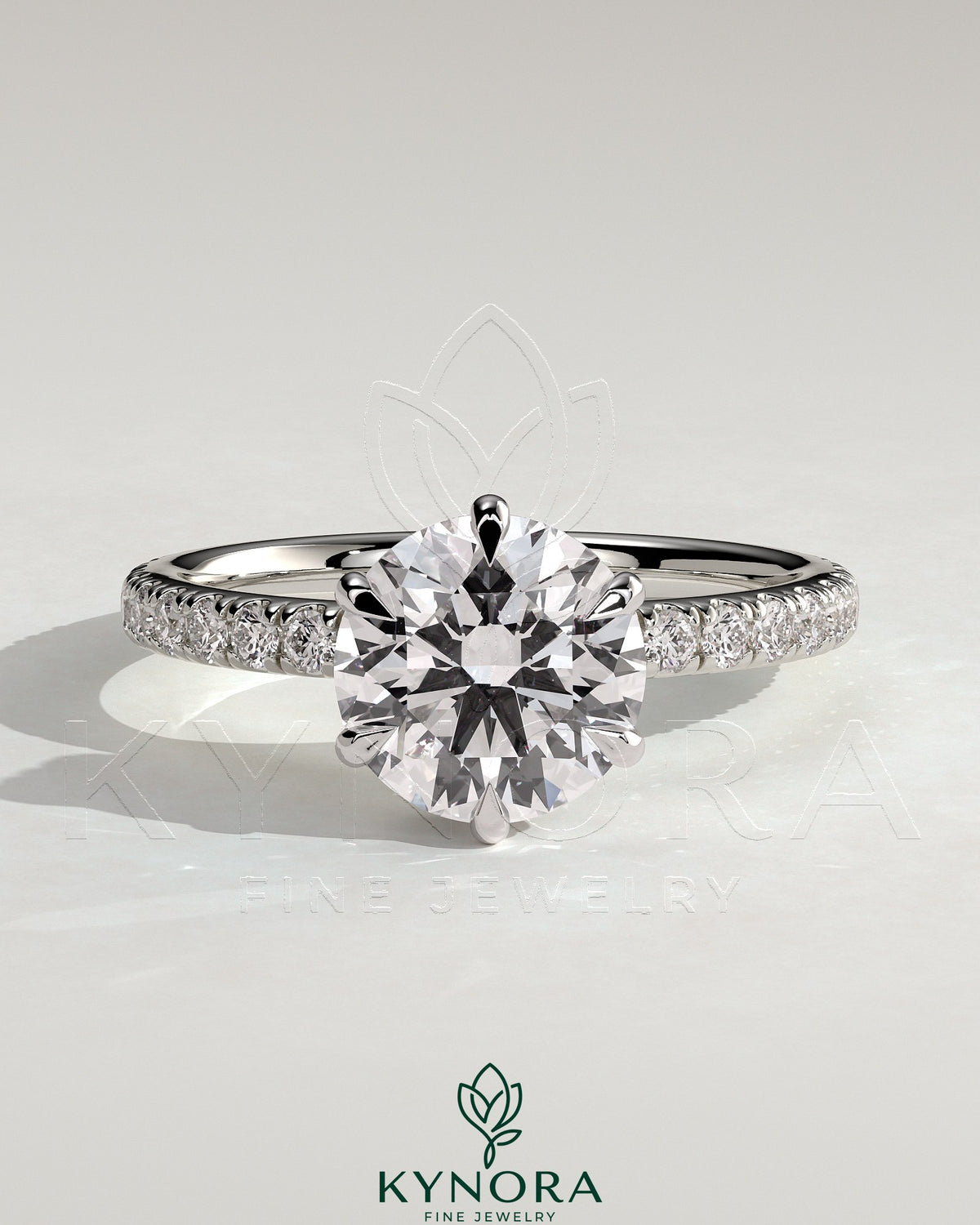 Kynora CJ 2ct round claw solitaire engagement ring with wrap-around hidden halo and pave band, showcasing intricate design and sparkle.