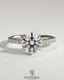 Kynora CJ 2ct round claw solitaire engagement ring with wrap-around hidden halo and pave band, showcasing intricate design and sparkle.