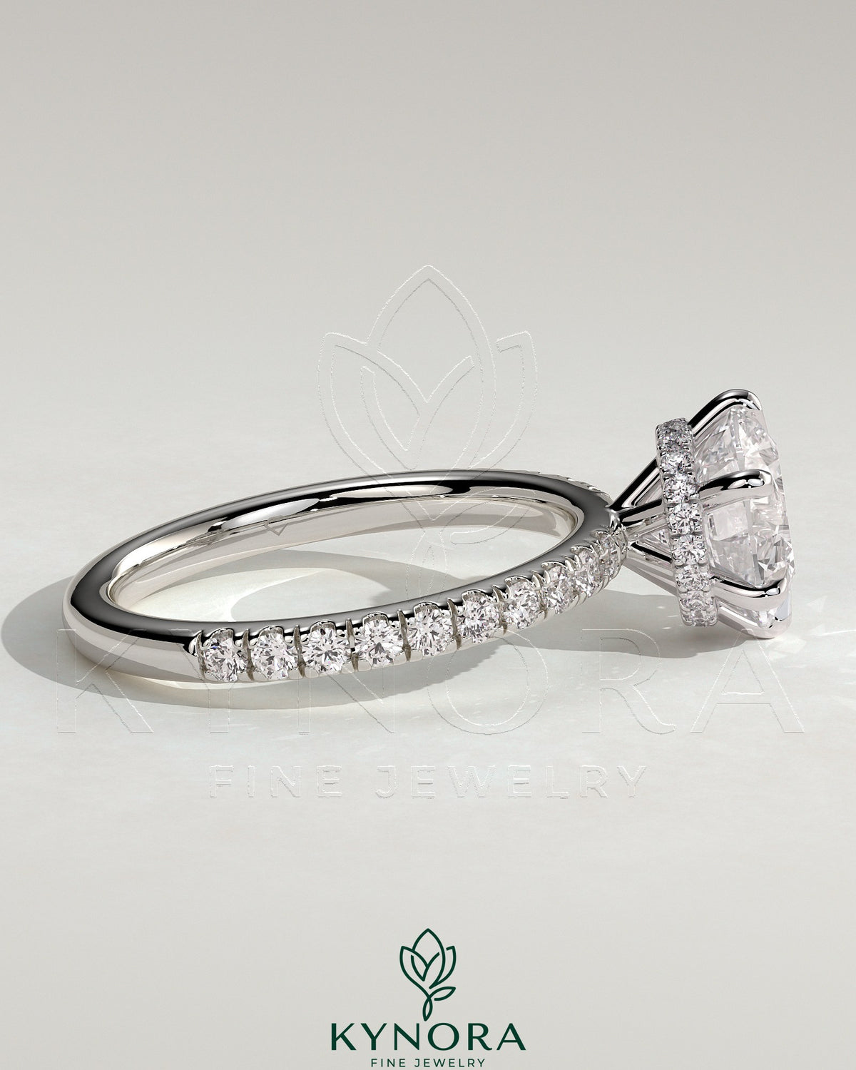 Kynora CJ 2ct round claw solitaire engagement ring with wrap-around hidden halo and pavé band in sterling silver.