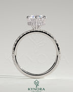 Kynora CJ 2ct round claw solitaire engagement ring with wrap-around hidden halo and pave band, showcasing elegant diamond setting.
