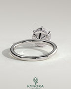 Kynora CJ 2ct round claw solitaire engagement ring with wrap-around hidden halo, showcasing a sparkling diamond setting.
