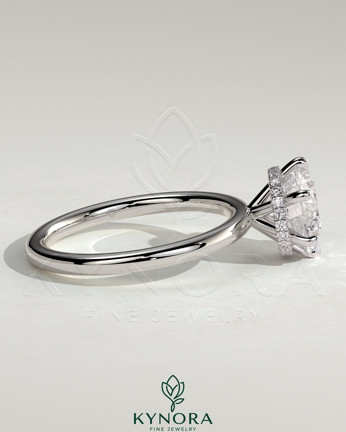 Kynora CJ 2ct round claw solitaire engagement ring with a wrap-around hidden halo, featuring sparkling diamond accents.