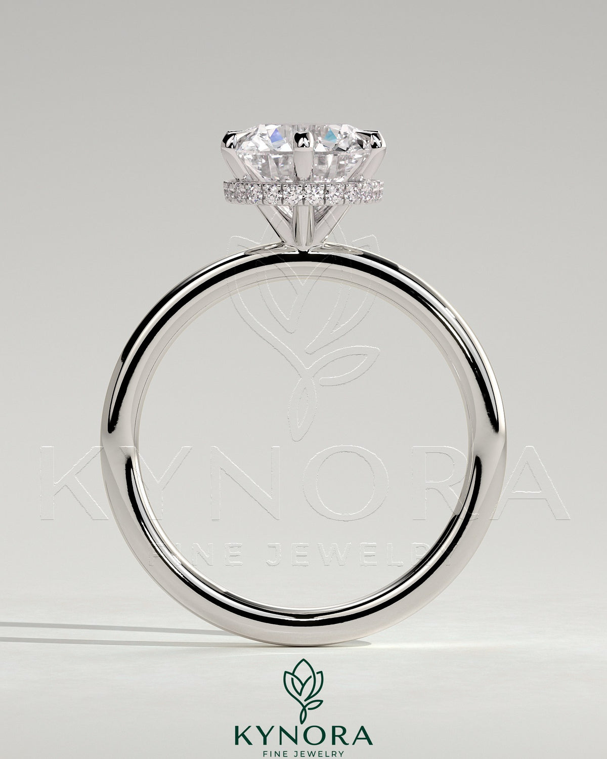 Kynora CJ 2ct round claw solitaire engagement ring with wrap-around hidden halo, showcasing a sparkling central diamond and intricate band design.