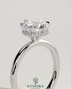 Kynora CJ 2ct round claw solitaire engagement ring with wrap-around hidden halo and classic design.