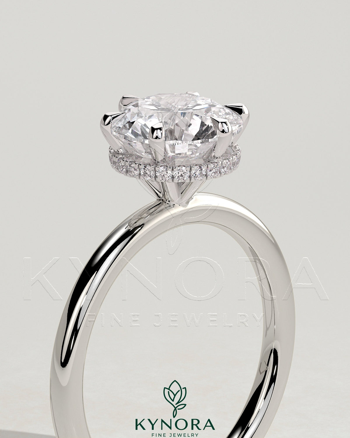 Kynora CJ 2ct round claw solitaire engagement ring with wrap-around hidden halo and classic design.