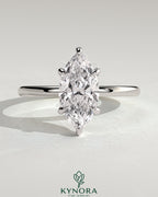 Elegant solitaire engagement ring by Kynora CJ featuring a 2-carat marquise-shaped diamond in a classic claw setting.
