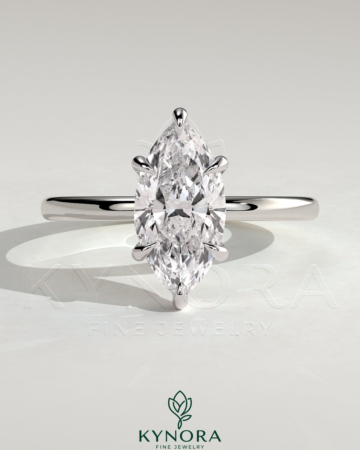 Elegant solitaire engagement ring by Kynora CJ featuring a 2-carat marquise-shaped diamond in a classic claw setting.