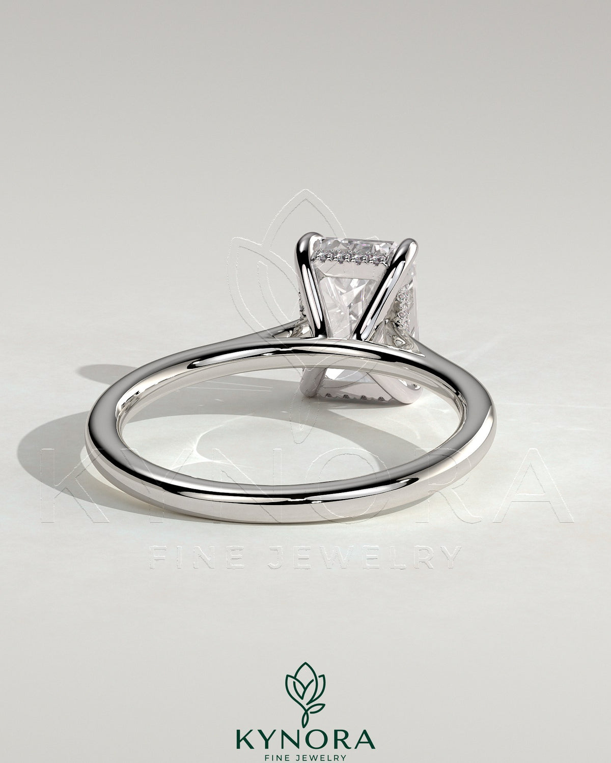 Kynora CJ Radiant Claw Solitaire engagement ring with hidden halo, tapered band, and cathedral high setting showcasing the sparkling gemstone.