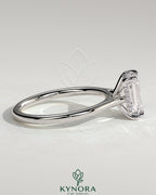 Kynora CJ Radiant Claw Solitaire Engagement Ring with hidden halo, tapered band, and cathedral high setting, showcasing a sparkling center stone.