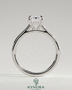 Kynora CJ radiant claw solitaire engagement ring with hidden halo, tapered band, and cathedral high setting featuring a sparkling central gemstone.