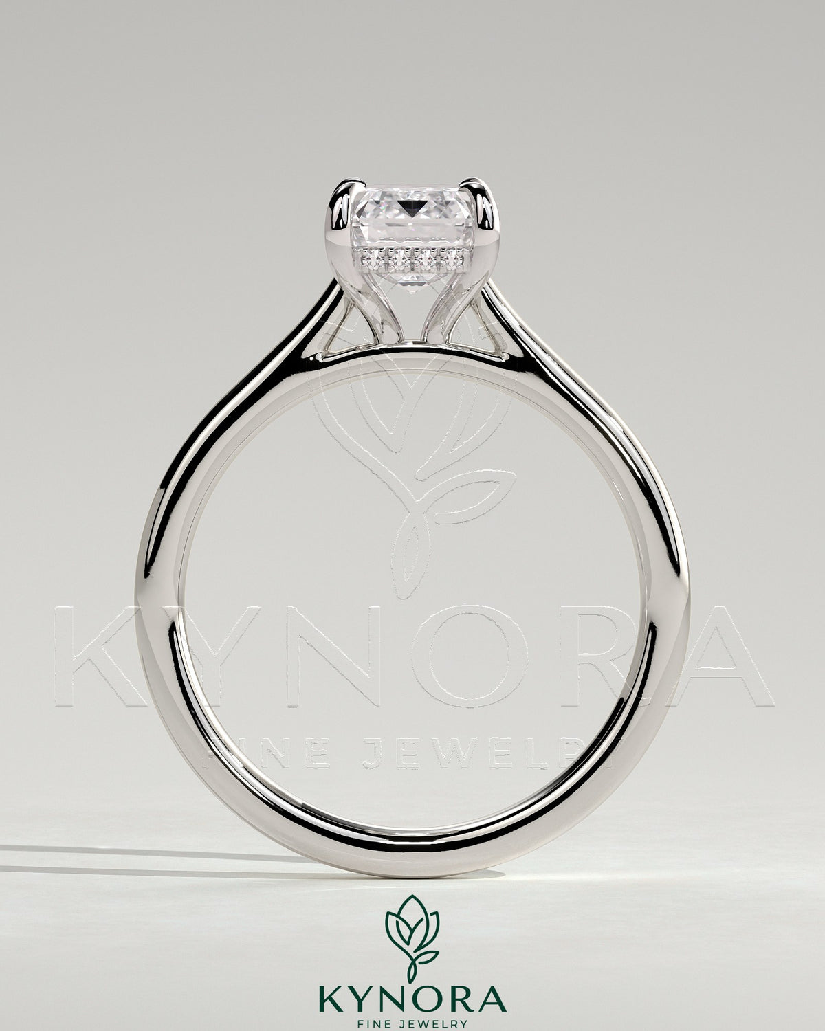 Kynora CJ radiant claw solitaire engagement ring with hidden halo, tapered band, and cathedral high setting featuring a sparkling central gemstone.