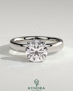Kynora CJ statement 2ct round diamond claw solitaire engagement ring with cigar band and hidden halo, showcasing elegant jewelry craftsmanship.
