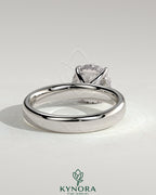Kynora CJ statement 2ct round claw solitaire engagement ring with cigar band and hidden halo, showcasing elegant jewelry design.