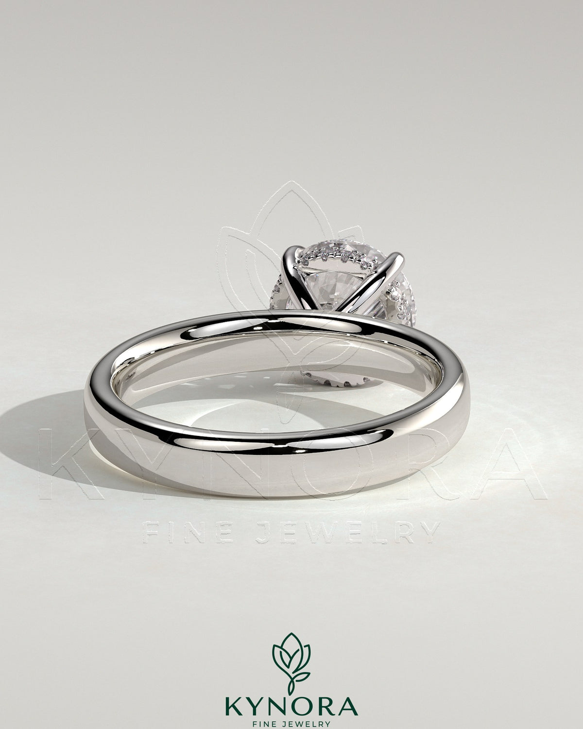 Kynora CJ statement 2ct round claw solitaire engagement ring with cigar band and hidden halo, showcasing elegant jewelry design.