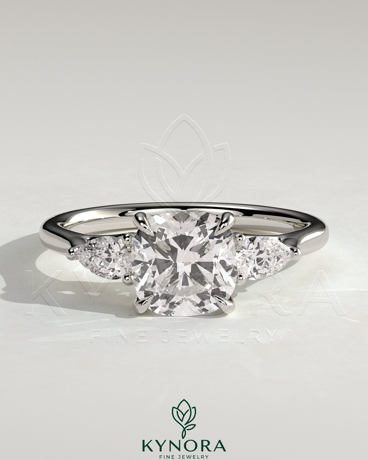 Kynora CJ 2ct cushion claw trilogy engagement ring with pear side stones and open trellis gallery design.