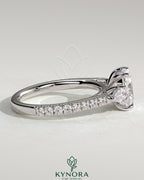 Kynora CJ 2ct elongated cushion trilogy engagement ring with pear side stones and pave band, elegant three-stone design.