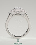 Kynora CJ 2ct elongated three-stone engagement ring with pear side stones and pave band, showcasing elegant diamond design.