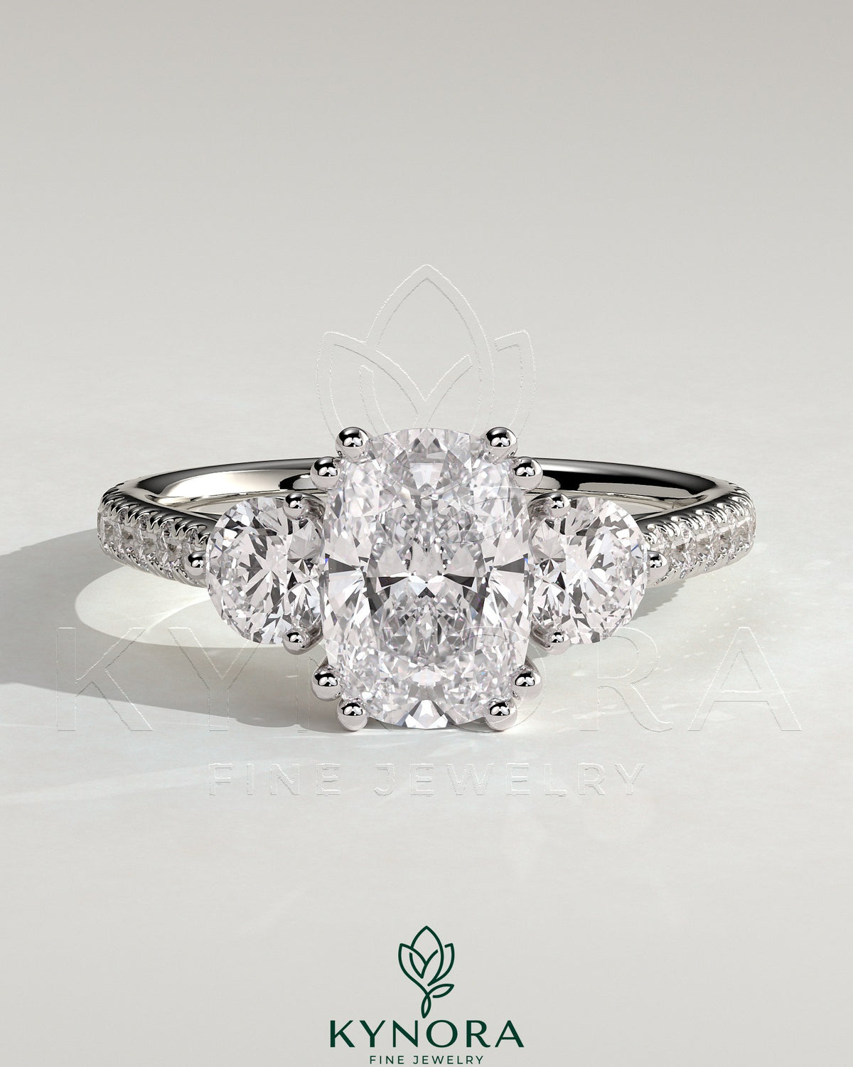 Kynora CJ 2ct elongated three-stone engagement ring with round side stones, pave band, and cathedral setting. Main image