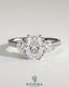 Kynora CJ 2ct elongated three-stone engagement ring with round side stones, pave band, and cathedral setting.