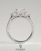 Kynora CJ 2ct elongated cushion double claw trilogy engagement ring with round side stones, pave band, cathedral setting, jewelry image.