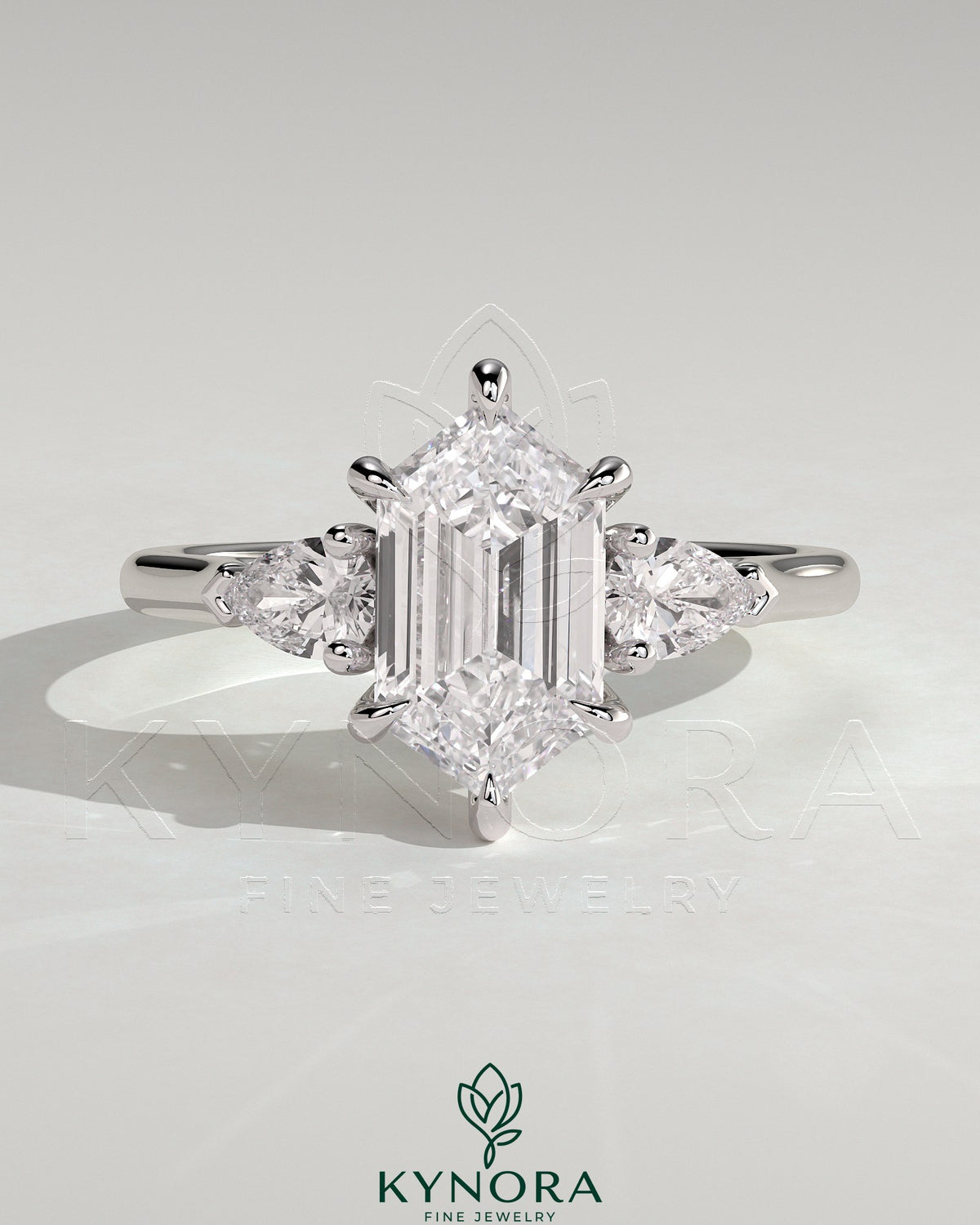 Kynora CJ three-stone engagement ring with 2-carat elongated hexagon center, pear side stones, and cathedral setting. Main image
