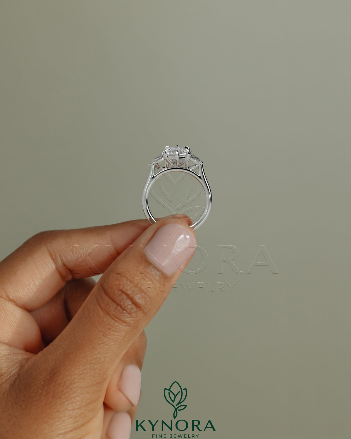Kynora CJ 2ct elongated hexagon claw trilogy engagement ring with pear side stones and cathedral setting.