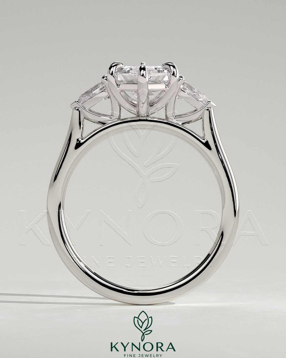 Kynora CJ 2ct elongated hexagon claw trilogy engagement ring with pear side stones and cathedral setting, showcasing intricate design.
