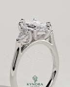 Kynora CJ 2ct elongated hexagon claw trilogy engagement ring with pear side stones and cathedral setting, detailed close-up image.