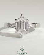 Kynora CJ 2ct elongated hexagon claw trilogy engagement ring with tapered baguette side stones and cathedral setting.