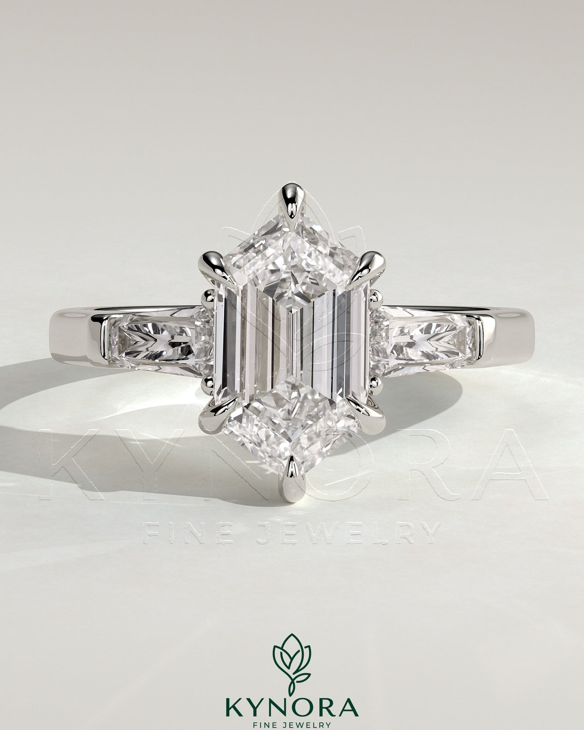 Kynora CJ 2ct elongated hexagon claw trilogy engagement ring with tapered baguette side stones and cathedral setting.