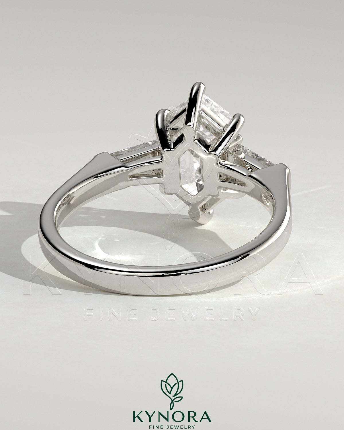 Kynora CJ 2ct elongated hexagon claw trilogy engagement ring with tapered baguette side stones and cathedral setting.