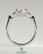 Kynora CJ 2ct elongated hexagon claw trilogy engagement ring with tapered baguette side stones and cathedral setting.