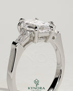 Kynora CJ 2ct elongated hexagon three-stone engagement ring with tapered baguette side stones and cathedral setting.