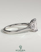 Kynora CJ 2ct emerald claw trilogy engagement ring with kite side stones, showcasing a three-stone design in sterling silver.